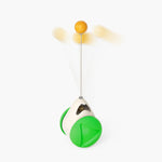 Green windmill cat toy with white base and orange ball on top