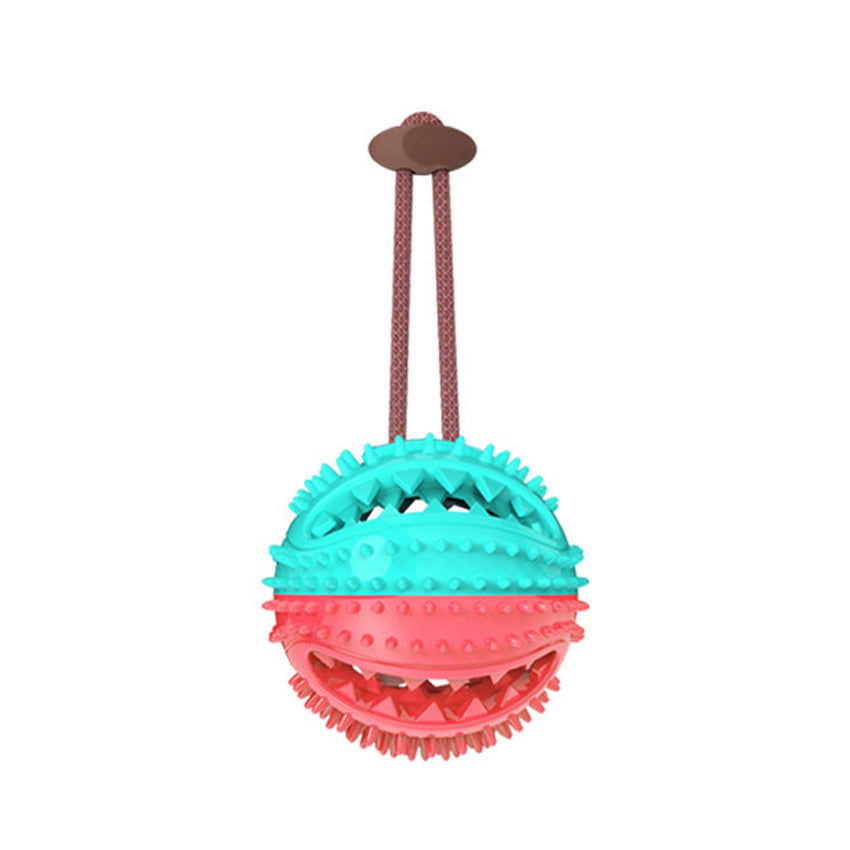 Dog chew ball toy with ridged teal and red spiky ball and brown handle straps