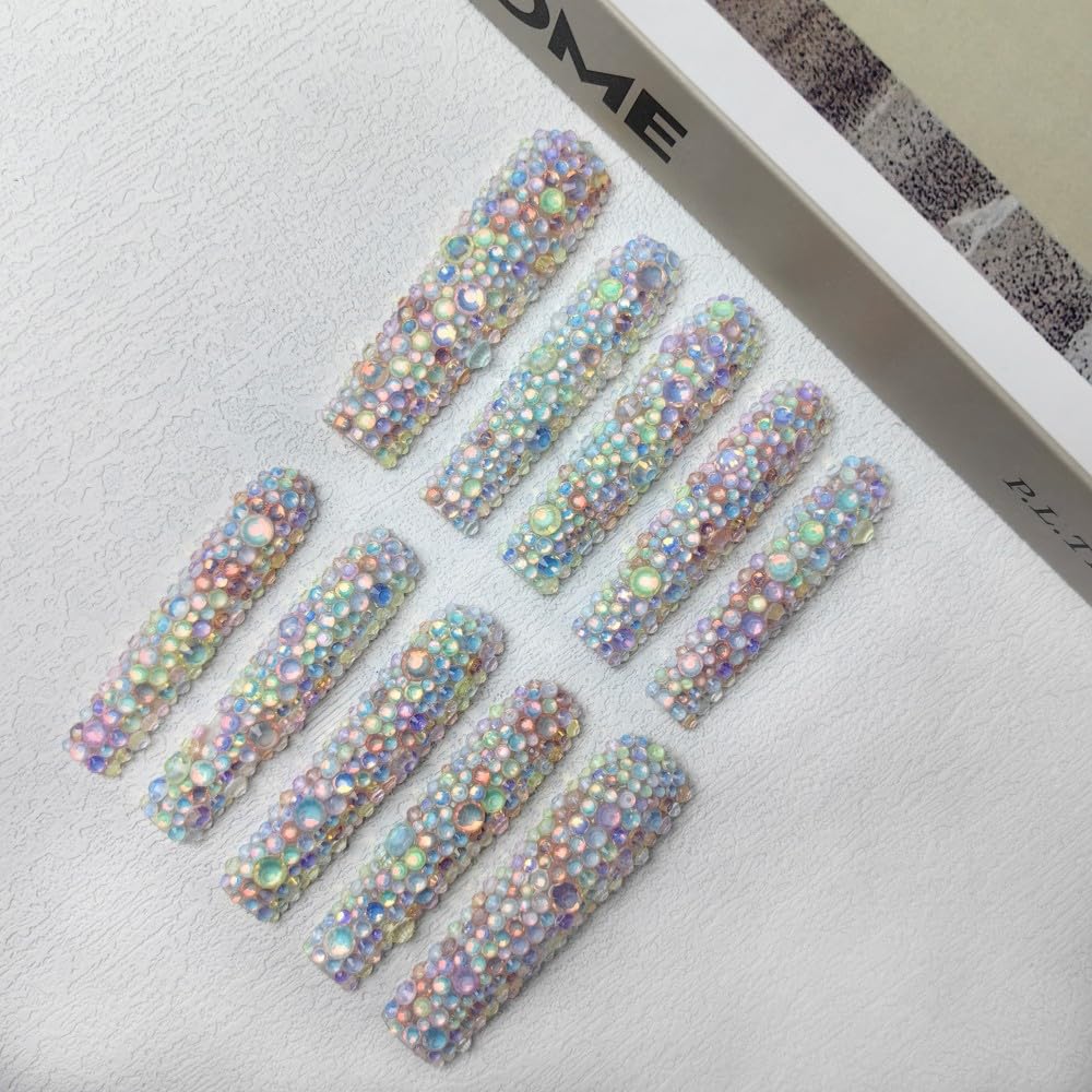 Pastel galaxy press-on nails arranged on a card, full coverage 3D crystal rhinestones
