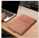 Laptop sleeve bag in tan/brown PU leather with front flap and label patch