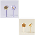Set of two cat grooming comb brushes, lavender and cream, with spiked paw heads