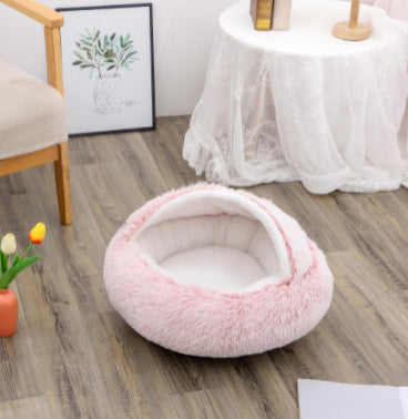Round plush pet bed in pink, empty bed with cushioned interior