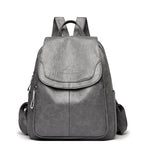 Women's PU leather travel backpack with front flap and side zippers, gray