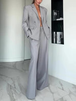 Light gray single-button blazer with notch lapels and flap pockets, with wide-leg pants