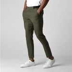 Olive green slim-fit trousers with elastic waistband, button closure, front pockets