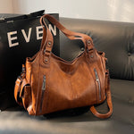 Women’s retro PU handbag with top handles and crossbody strap, tan/brown, zip pockets.