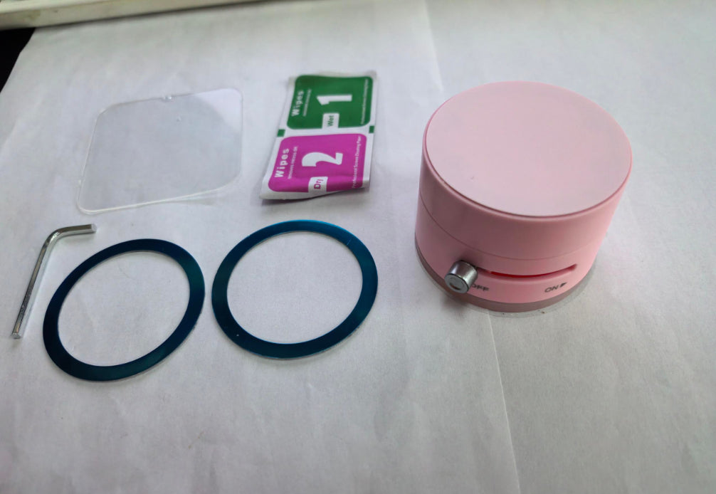 Pink suction cup magnetic phone holder with mounting rings and small accessories