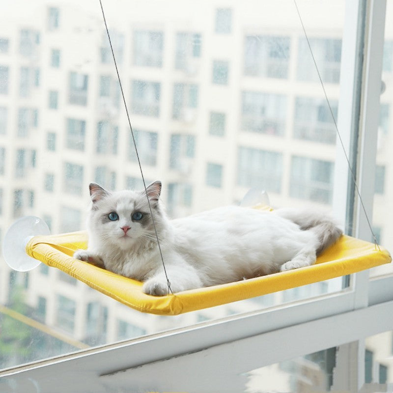 Cat window hammock perch with suction cups, yellow cushion, white cat lying down