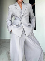 Light gray blazer and wide-leg pants suit with notch lapels and flap pockets, front view