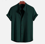 Dark green short sleeve button-up shirt with pointed collar and vertical textured fabric