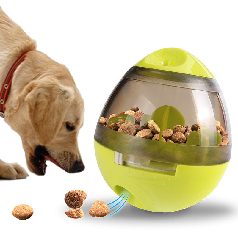 Green pet food dispenser ball toy with clear lid and feeder chute, shown with treats