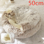 Round tan shag plush pet bed with pet curled inside