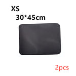 Cat litter mat, textured dark fabric, rounded-rectangle shape with stitched border