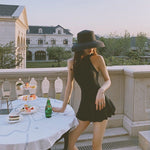 One-piece swimsuit with sleeveless high neckline and flared skirt peplum, dark