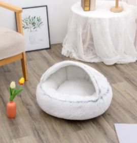 Round plush pet bed in white/cream, front view of empty circular bed