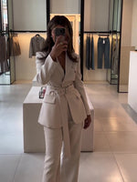 Beige belted blazer and high-waist pants set with long sleeves, buttoned blazer, wide-leg pants.