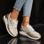 Women's gold lace-up sneakers with side zip, thick white sole and ankle chain detail