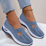 Women's mesh slip-on flats in blue, cutout toe and white sole.