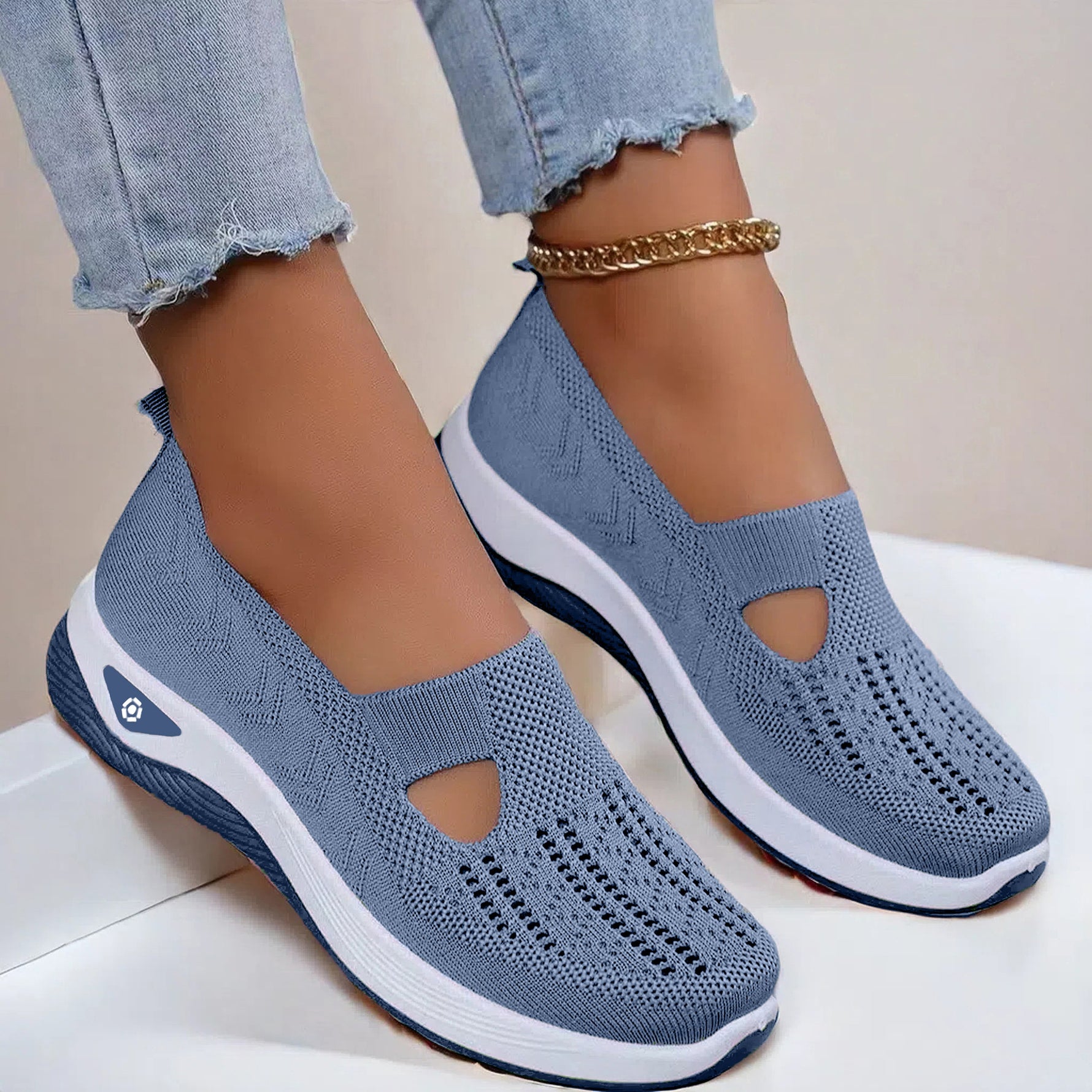 Women's mesh slip-on flats in blue, cutout toe and white sole.