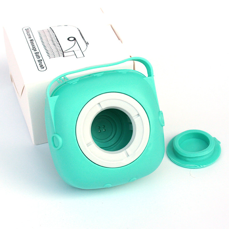 Teal green silicone bath massage brush head with open center cup and snap-on lid