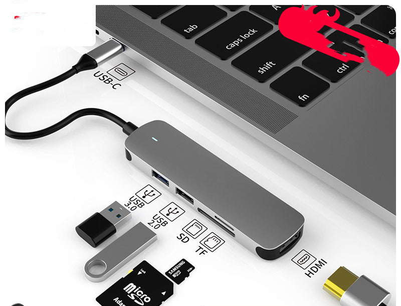 USB-C hub docking station connected to laptop, shows HDMI and SD/Tf card slots