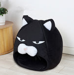 Black cat-face pet bed nest with hood opening and plush cushioned interior