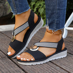 Black woven-strap sandals with round gold metal buckles, open toe, cushioned sole