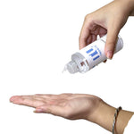 Tunmate toner bottle held over open palm, nozzle pointed downward
