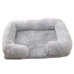 Light gray plush dog bed with padded sides and rounded bolster base