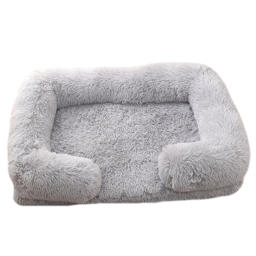 Light gray plush dog bed with padded sides and rounded bolster base