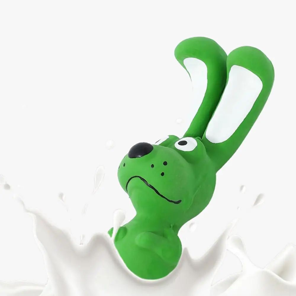 Green latex rabbit squeaky chew toy with white inner ears in mid-motion