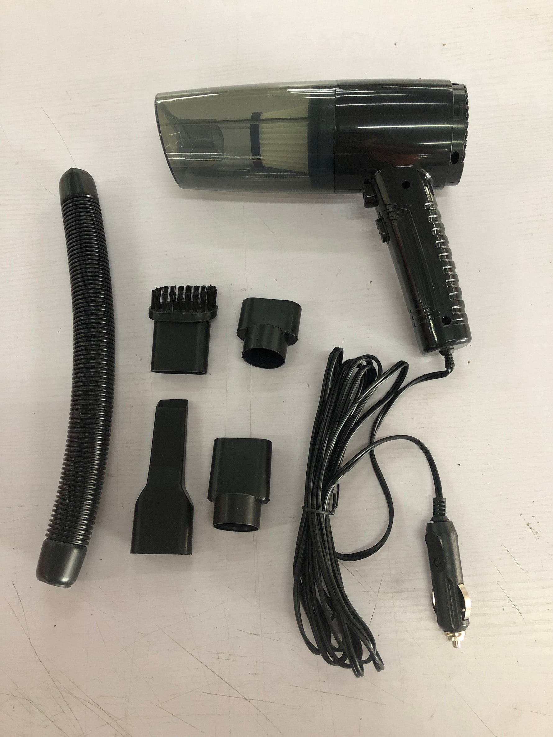 Vacuum cleaner kit with handheld unit, hose, and several detachable cleaning nozzles