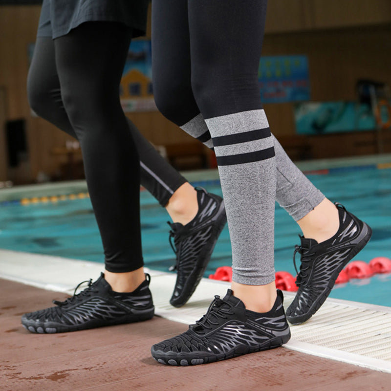 Black water shoes with lace-up closure and textured graphic pattern on the feet.