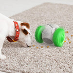 Teal-green slow feed balance pet toy with treat pieces spilling from ports