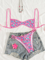 Women’s floral bikini set with pink triangle top and matching tie-side bottoms