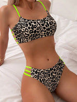 Leopard print push-up bikini with neon green contrast straps and high-cut bottom