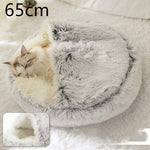 Round gray shag plush pet bed with cat resting inside the rim