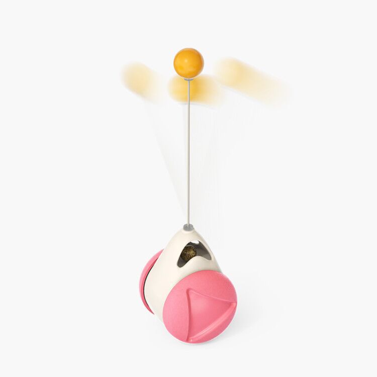Pink windmill cat toy with white base and orange ball on top