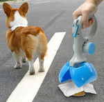 Portable dog waste scooper with blue bin and white handle, held near standing dog.