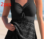 Black lace one-piece swimsuit with padded cups, tie-front neckline, and patterned lace skirt panel