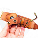 Orange leather dog collar close-up with round tracker window and metal grommets