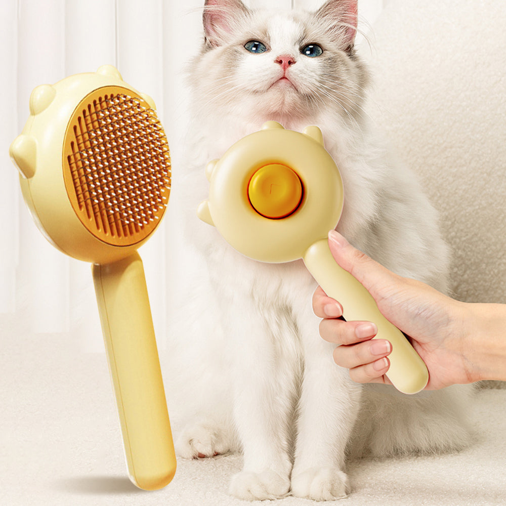 Cat and dog grooming massage brush with yellow handle and brown bristle head