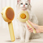 Cat and dog grooming massage brush with yellow handle and brown bristle head