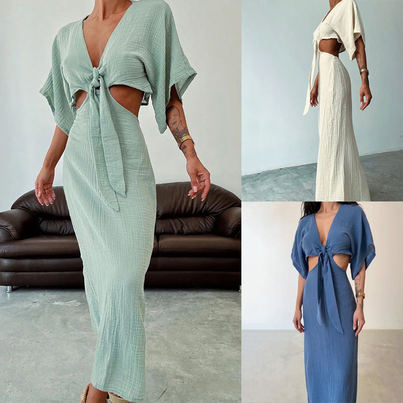 Women's green maxi dress with tie-front V-neck and cutout shoulders, asymmetrical hem