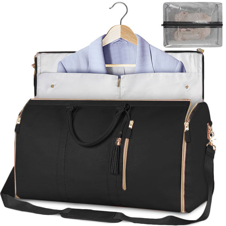 Black waterproof duffle bag open with garment storage panel and zipper pockets