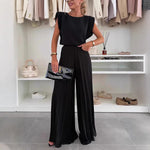 Black sleeveless round-neck top with pleated wide-leg trousers, two-piece set
