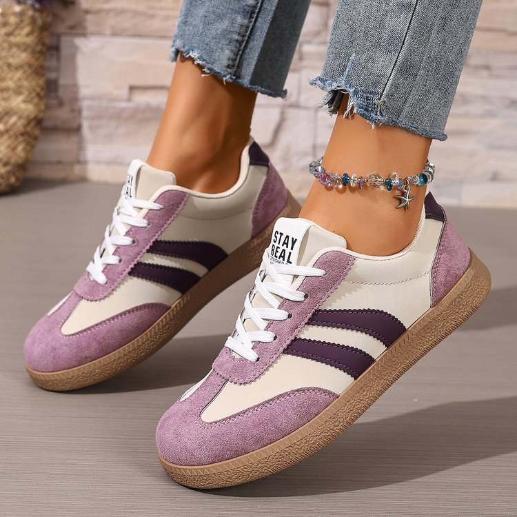 Women's casual sneakers with white upper and purple panels, lace-up, gum outsole