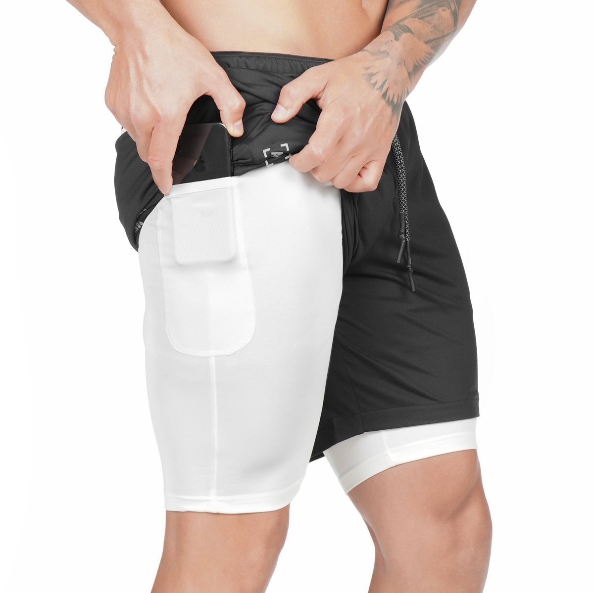 Black pocket compression shorts with large white side pocket panel and drawstring