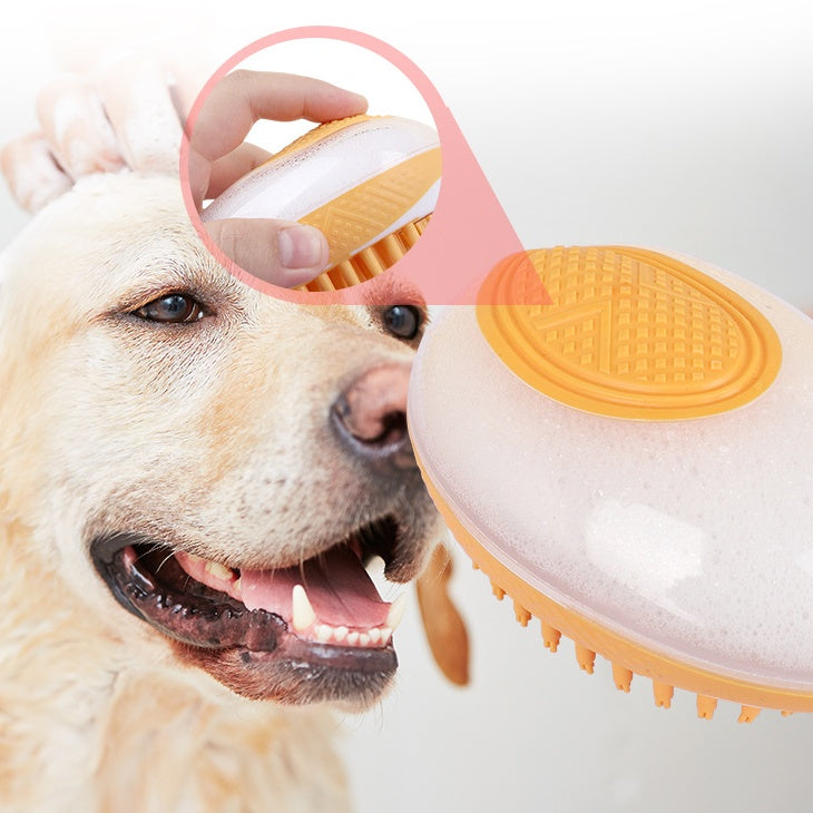 Pet bath brush with orange silicone massage pad and orange bristles under hand