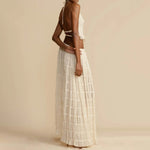 White halter crop top and tiered pleated maxi skirt set, sleeveless with cutout back